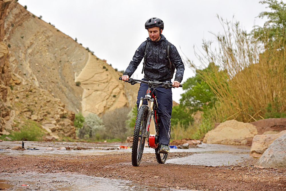 Bikers crossing the river with ford near the village of Tighza, Ounila River valley, Ouarzazate Province, region of Draa-Tafilalet, Morocco, North West Africa