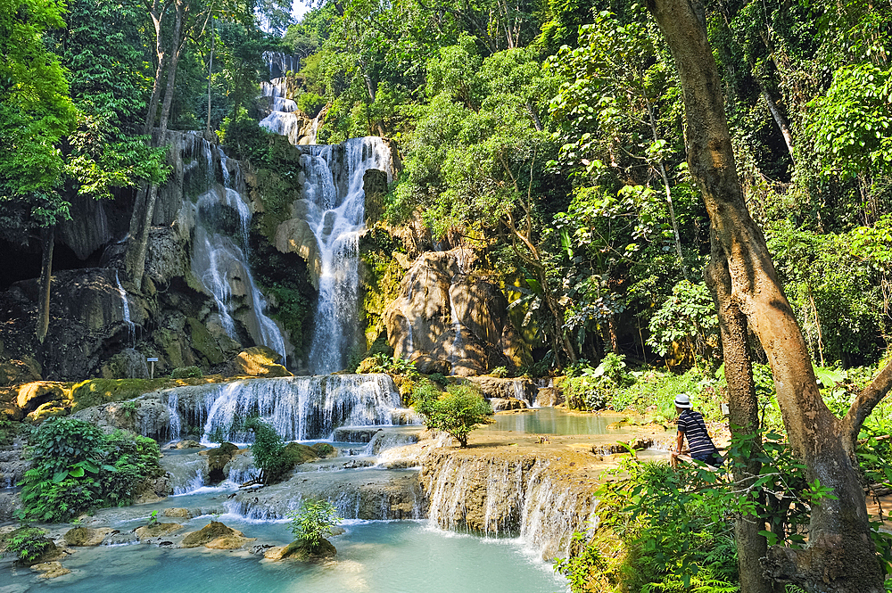 Man admiring the Kuang Si waterfalls, Luang Prabang, Laos, Southeast Asia