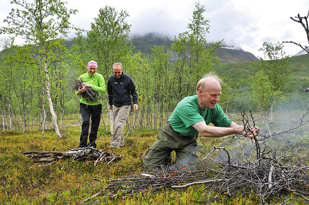 People making a campfire,Nordmannvikdalen valley,region of Lyngen,County of Troms,Norway,Northern Europe