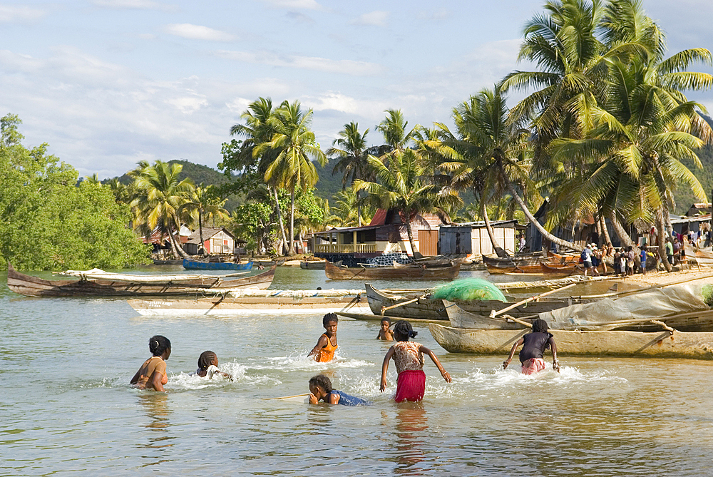 Children playing to catch fish, Ambatozavavy village,Nosy Be island,Republic of Madagascar,Indian Ocean