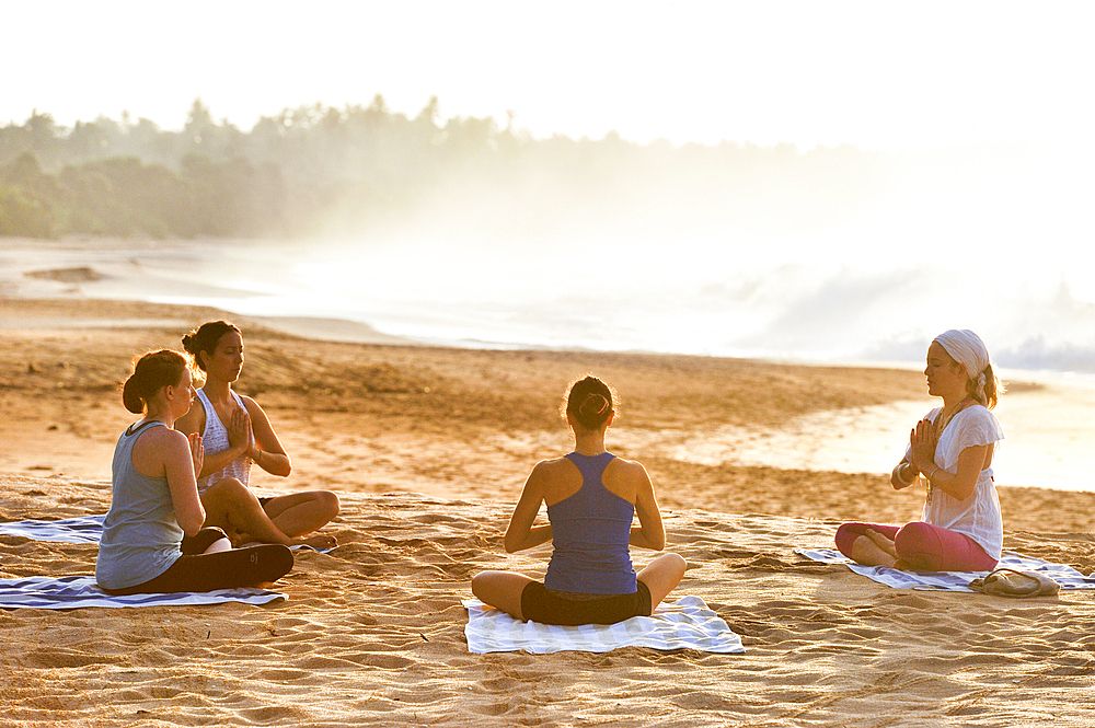 Yoga class on the beach beside the Sen Wellness Sanctuary, near Tangalle, South Coast of Sri Lanka, Indian subcontinent, South Asia
