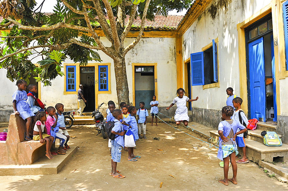 Pupils playing bungee jumping in the playground of the primary school in the village of Praia das Conchas, in the northern part of Sao Tome Island, Republic of Sao Tome and Principe,Africa