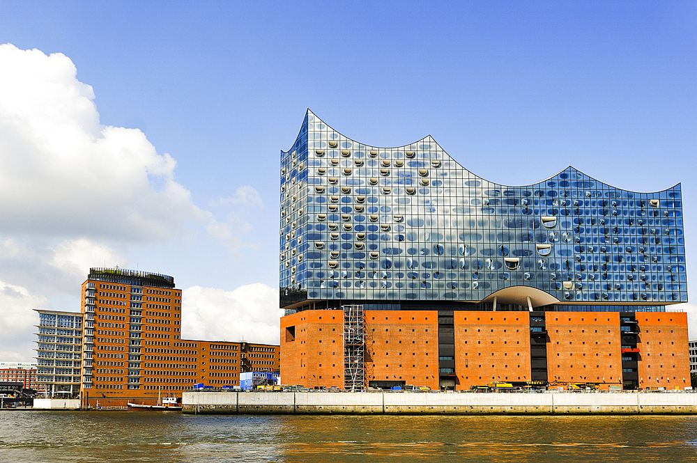 Elbphilharmonie, a concert hall built on top of an old warehouse building, by Swiss architecture firm Herzog and de Meuron, viewed from a ferry on Elbe river, HafenCity district, Hamburg, Germany, Europe