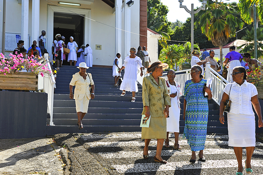 People outside the church after the Sunday mass in the village of Deshaies, Basse-terre, Guadeloupe, overseas region of France,Leewards Islands, Lesser Antilles, Caribbean