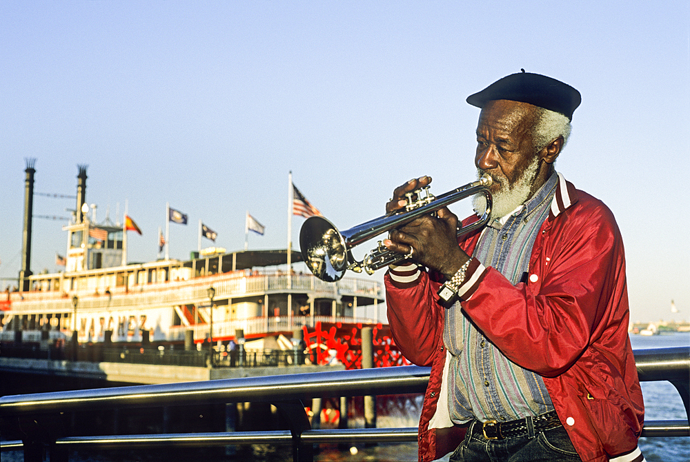 Trumpet player in front of the steamboat Natchez on the Mississippi River, New Orleans, Louisiana, USA
