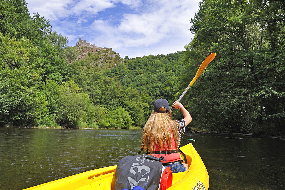 Canoeing on the Sioule River with the ruins of Chateau-Rocher in the background, Puy-de-Dome department, Auvergne-Rhone-Alpes region, France, Europe