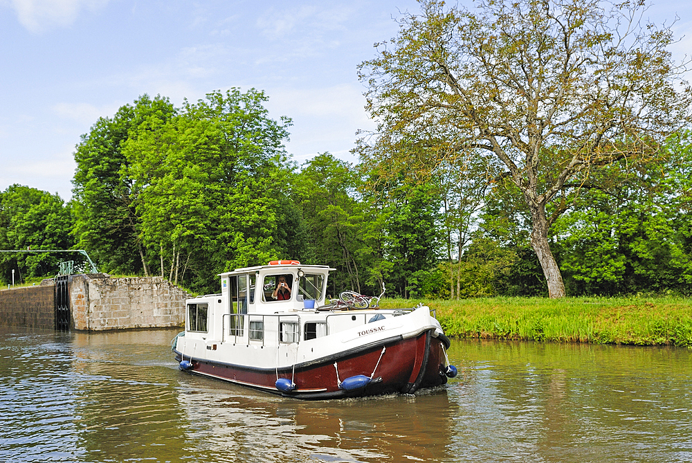Houseboat approaching a lock of Canal du Centre around Chagny,Saone-et-Loire department,Burgundy region,France,Europe