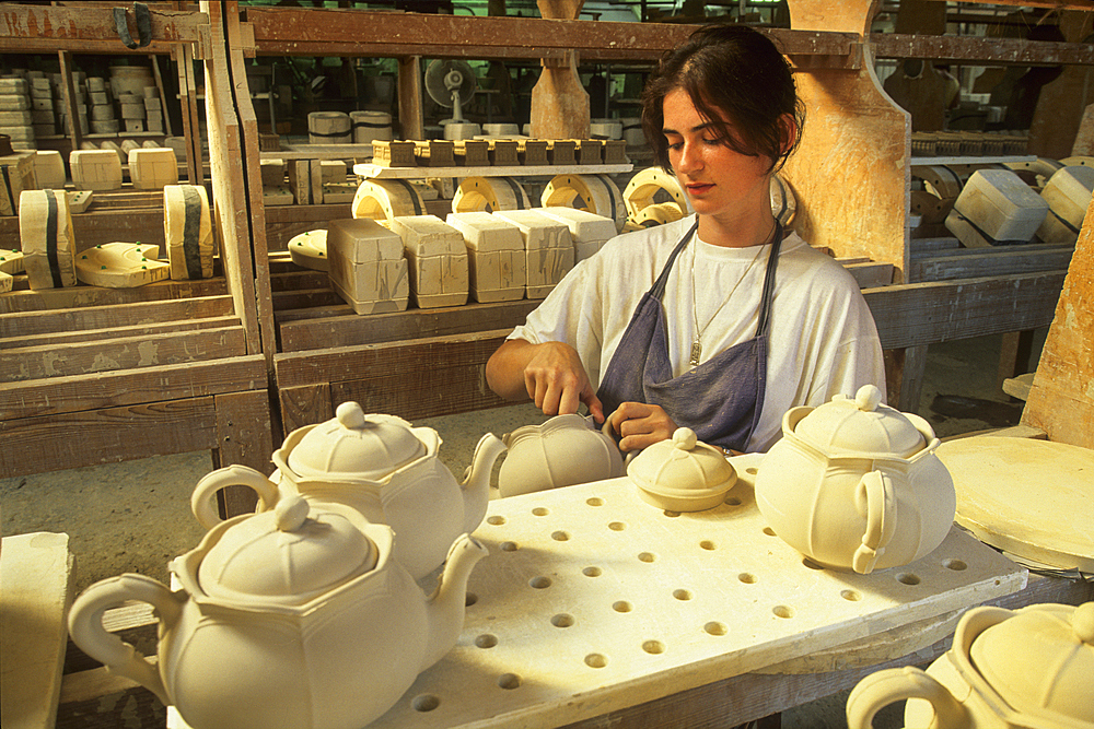 Skilled worker deburring some pieces,earthenware factory of Niderviller,Moselle department,Lorraine region,France,Europe