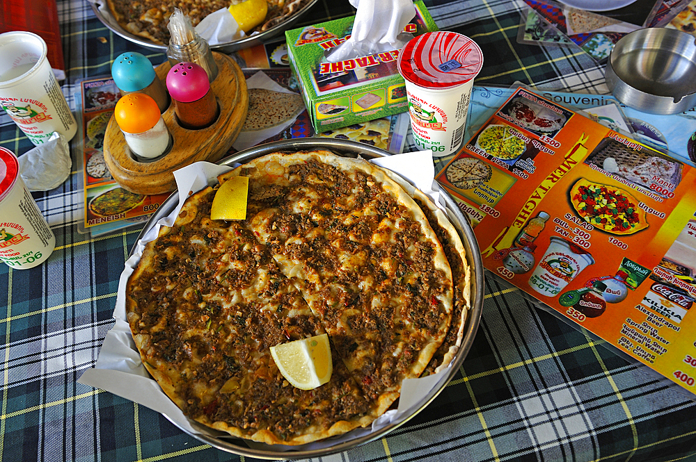 Lahmacun, a thin piece of dough topped with minced meat, served with than (Ayran), a kind of yogurt, at the Mer Taghe restaurant, Yerevan, Armenia, Eurasia