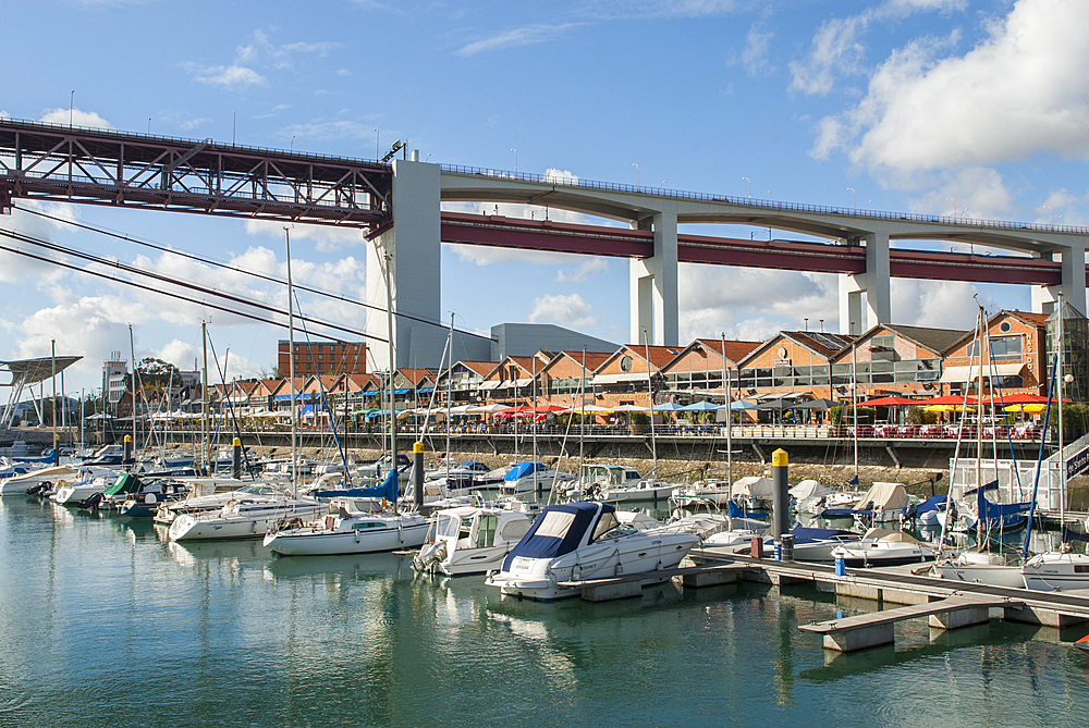 The Docks, the upscale commercial and retail district of the harbour area of Alcantara,under the 25 de Abril Bridge, Lisbon, Portugal, Europe
