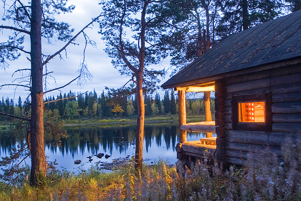 Traditional sauna on the bank of the Kemijoki River at dusk, Savukoski region,Lapland,Finland, Northern Europe