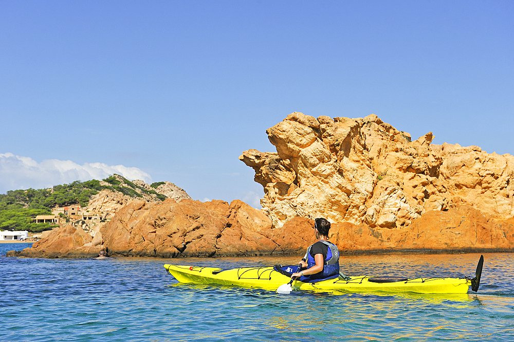 Kayaker in the inlet Cala Pregonda near Cape Cavalleria on the North Coast of Menorca, Balearic Islands, Spain, Mediterranean, Europe