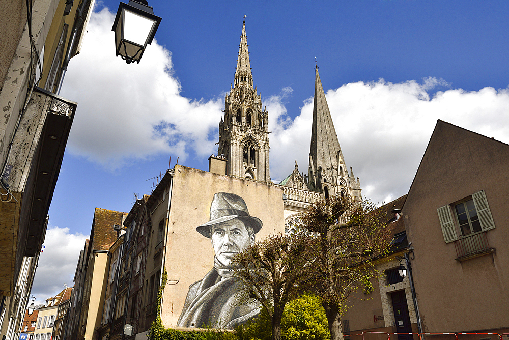 Mural with portrait of Jean Moulin, 1899-1943, hero of the French Resistance during World War II, with the towers of the cathedral in the background, City of Chartres, Eure-et-Loir department, Centre-Val-de-Loire region, France, Europe