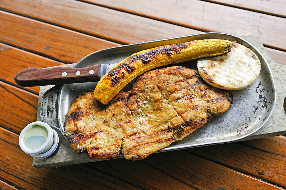 Grilled breast of chicken and fried plantain served in a restaurant at Cocora Valley, around Solento, department of Quindio, Colombia, South America