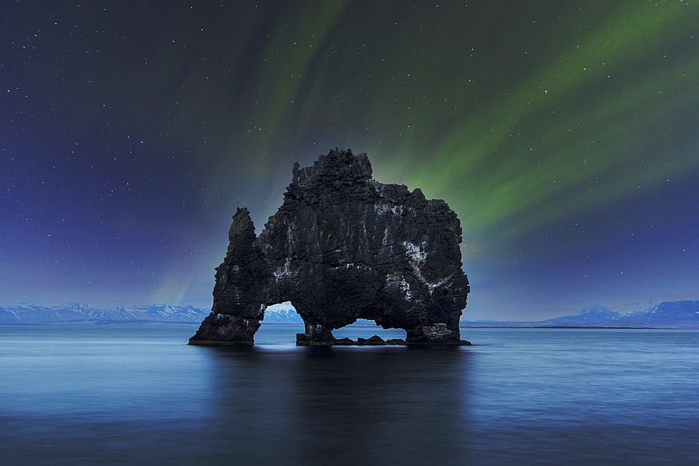 Northern lights over Hvitserkur, a spectacular rock formation in Iceland.