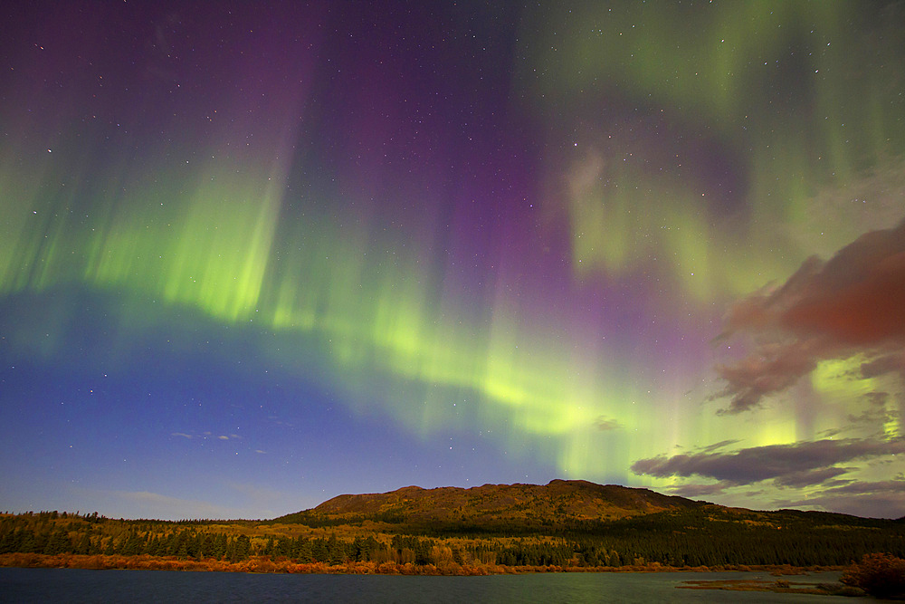 Aurora borealis with moonlight at Fish Lake, Whitehorse, Yukon, Canada.