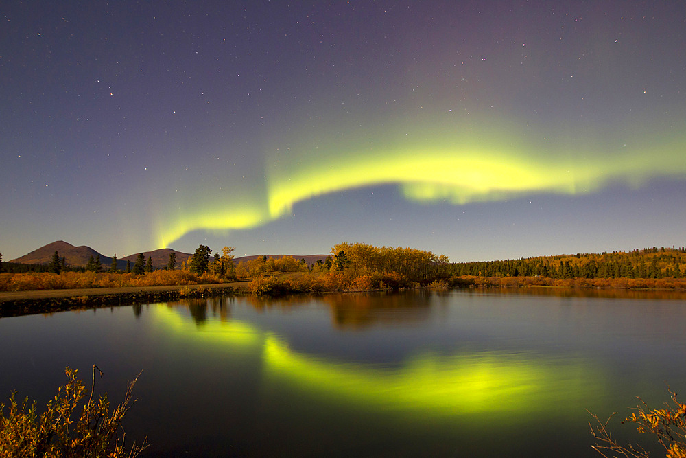 Aurora borealis with moonlight at Fish Lake, Whitehorse, Yukon, Canada.