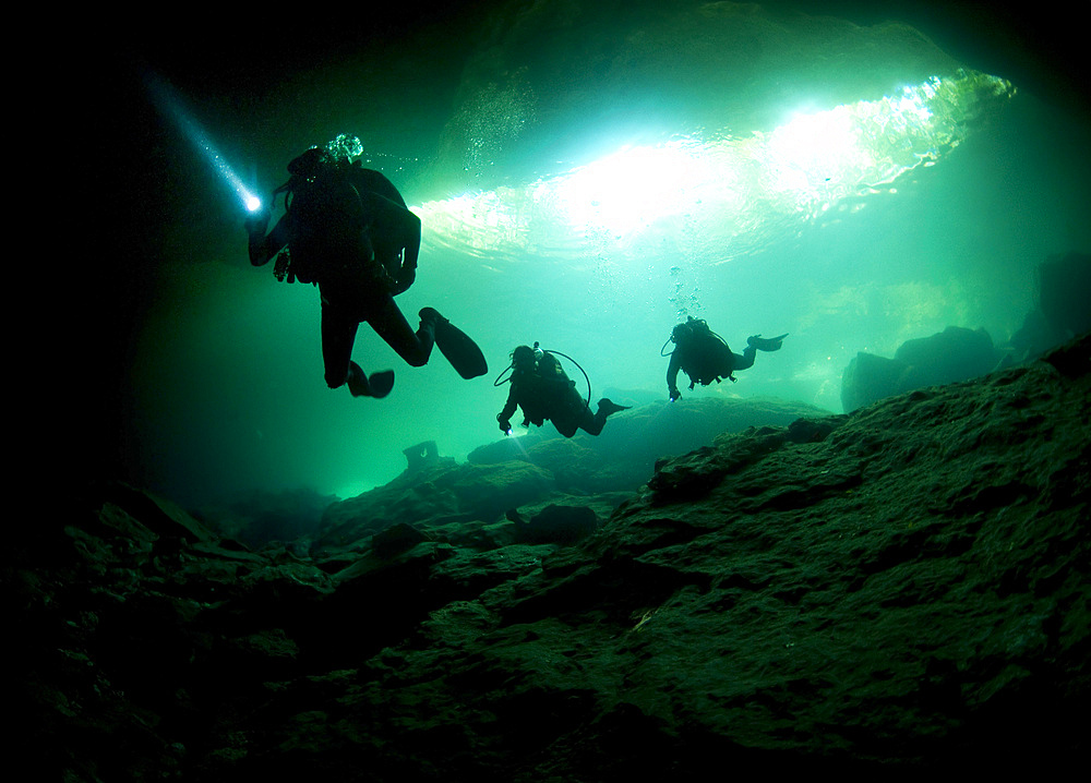 Cavern divers enter cenote system in Mexico's Yucatan Peninsula.