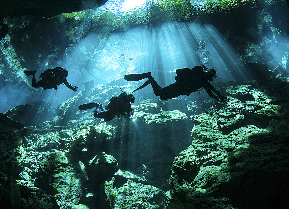 Diver enters the cavern system at Chac Mool cenote in the Riviera Maya area of Mexico's Yucatan Peninsula.