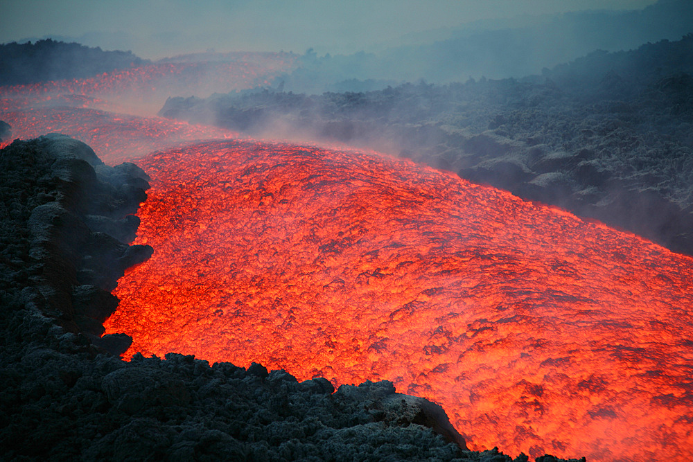 November 2006 - Lava flow at nightfall during eruption of Mount Etna volcano, Sicily, Italy.