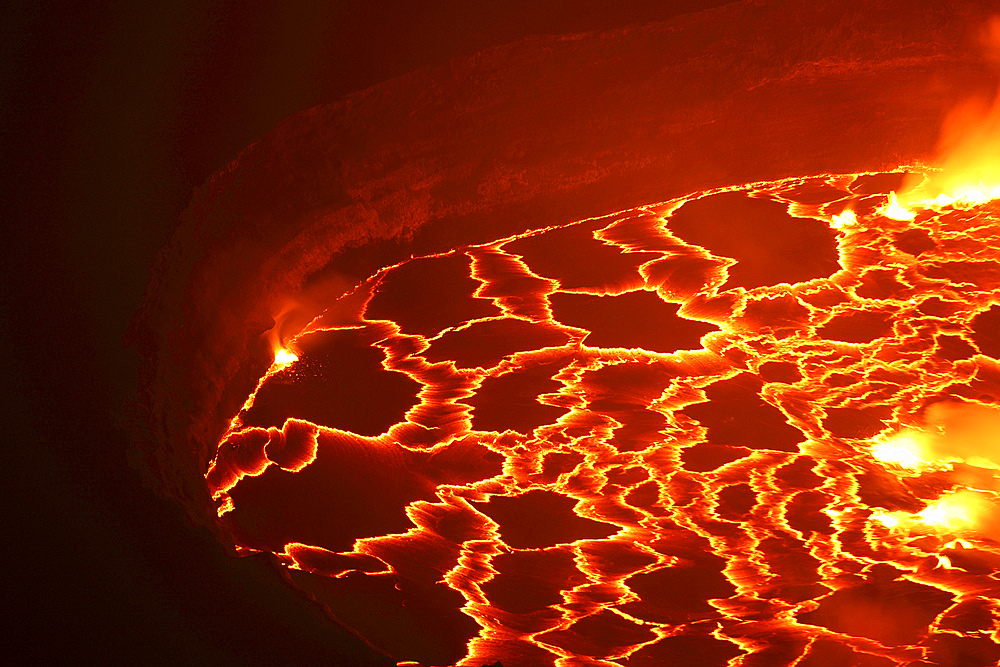January 21, 2011 - Lava rafts floating on lava lake in summit caldera, Nyiragongo Volcano, Democratic Republic of the Congo.