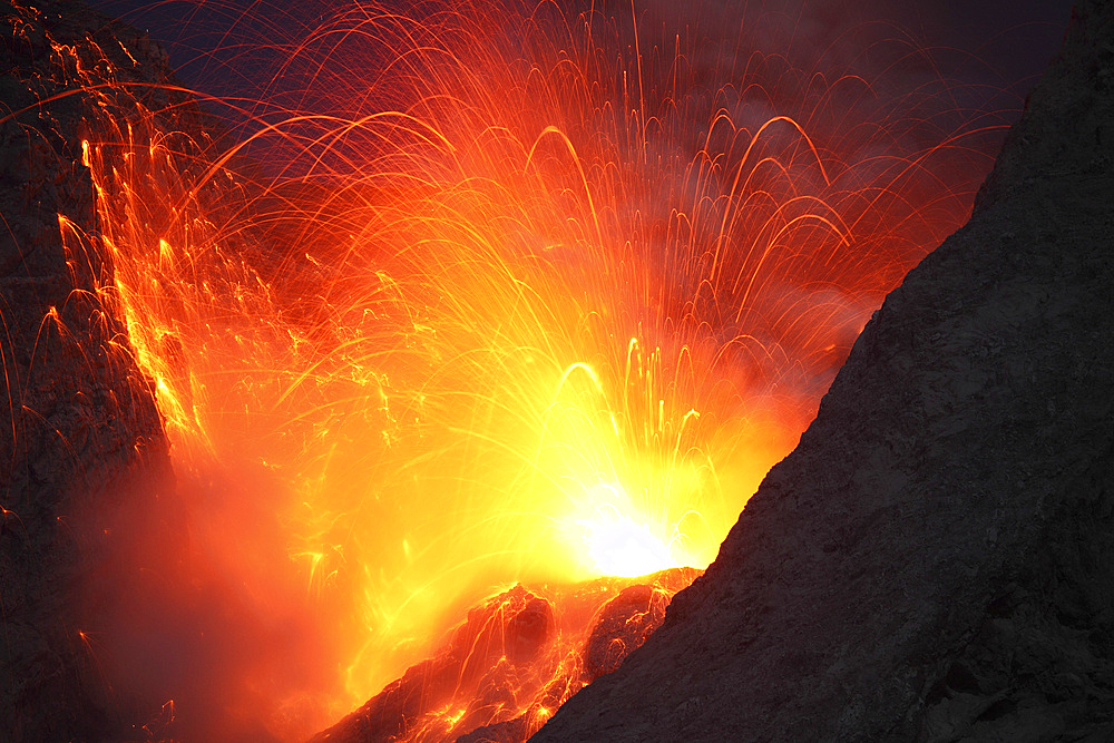 November 26, 2012 - Explosive strombolian type eruption of Batu Tara volcano, Komba Island, Indonesia. Trajectories of red glowing lava bombs are visible.