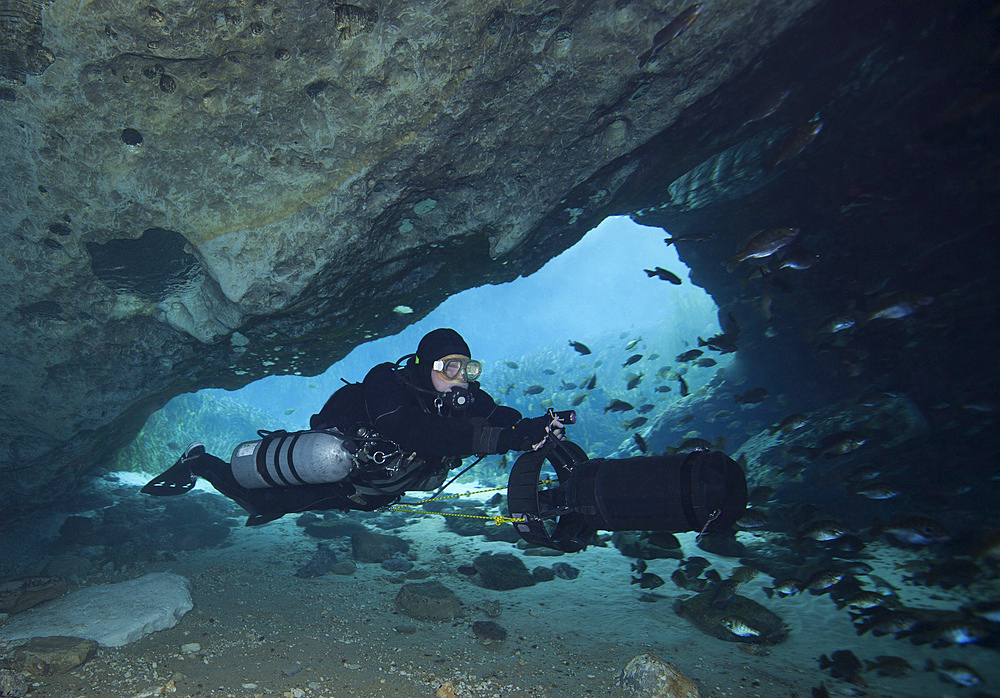 A technical cave diver using a diver propulsion vehicle (DPV) to dive into the Blue Springs state park cave system near Marianna, Florida.