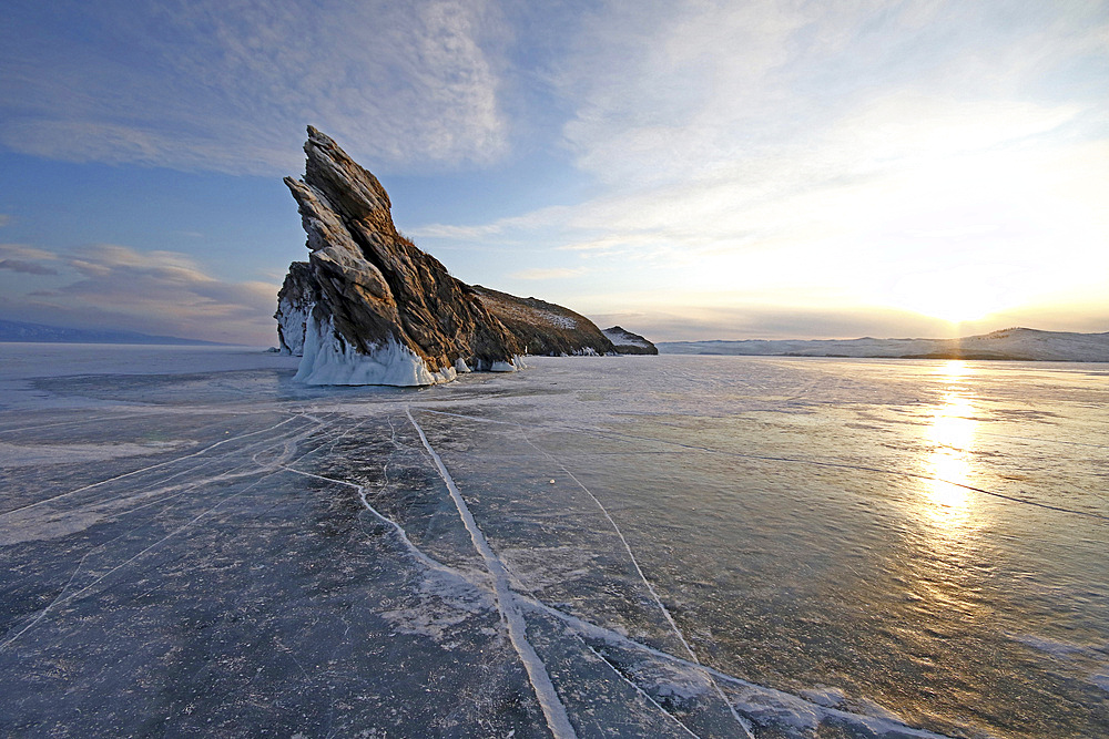 Rock formation protruding from the frozen lake, Lake Baikal, Russia.