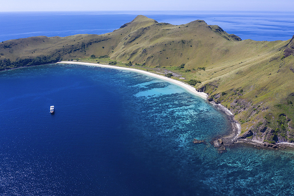 Aerial view of the idyllic island of Gili Banta just outside of Komodo National Park, Indonesia. This tropical area in the Lesser Sunda Islands is known for its marine biodiversity as well as its infamous Komodo dragons.