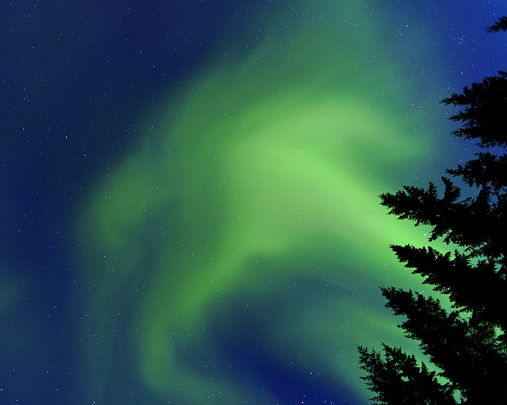 Aurora Borealis in Troms County, Norway. Auroras are the result of the emissions of photons in the Earth's upper atmosphere.