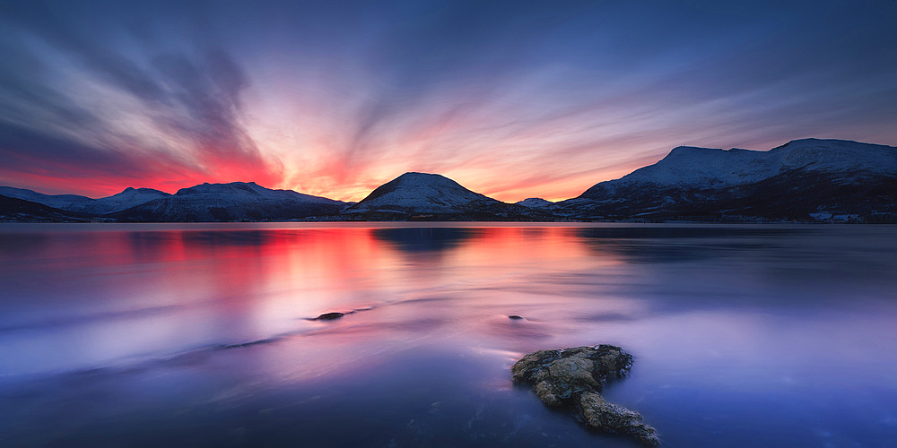 Sunset over Tjeldsundet, Troms County, Norway. Saetertinden and Harberget Mountains are visible in the background.