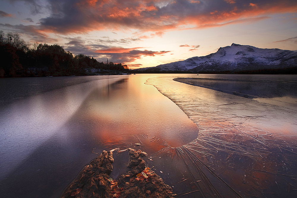 A frozen Straumen Lake on Tjeldoya Island in Nordland County, Norway. Strandtindan Mountain is in the background.