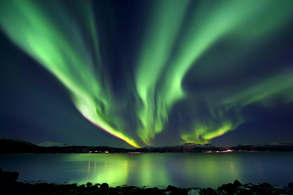 Aurora Borealis over Tjeldsundet in Troms County, Norway. Auroras are the result of the emissions of photons in the Earth's upper atmosphere.