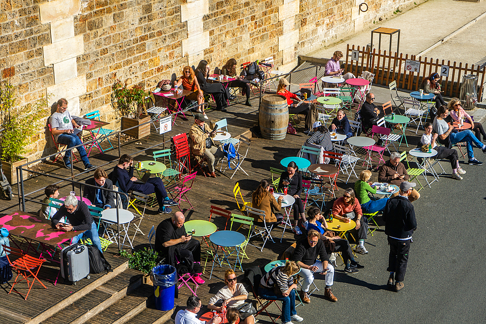 Colourful tables on a terrace beside the river on a sunny winter day