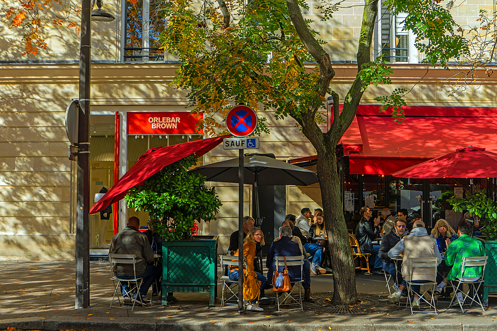 Terrace of restaurant Bar du Marche des Blancs Manteaux on Rue des Vieilles du Temple in autumn sunshine, Paris, France