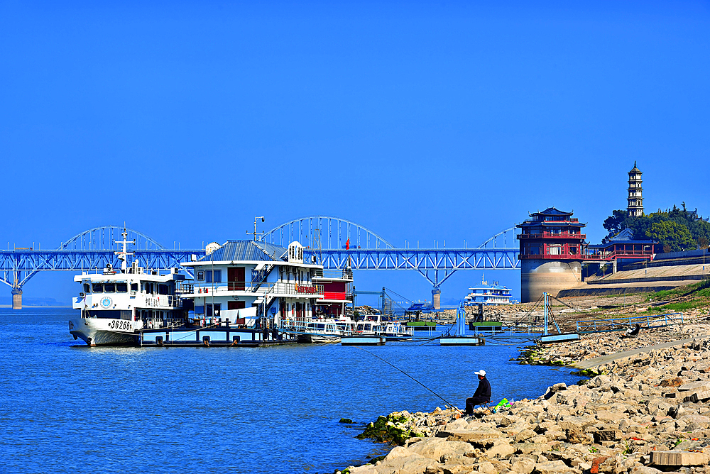 Man fishing by the Yangtze River in Jiujiang City, Jiangxi Province, China.
