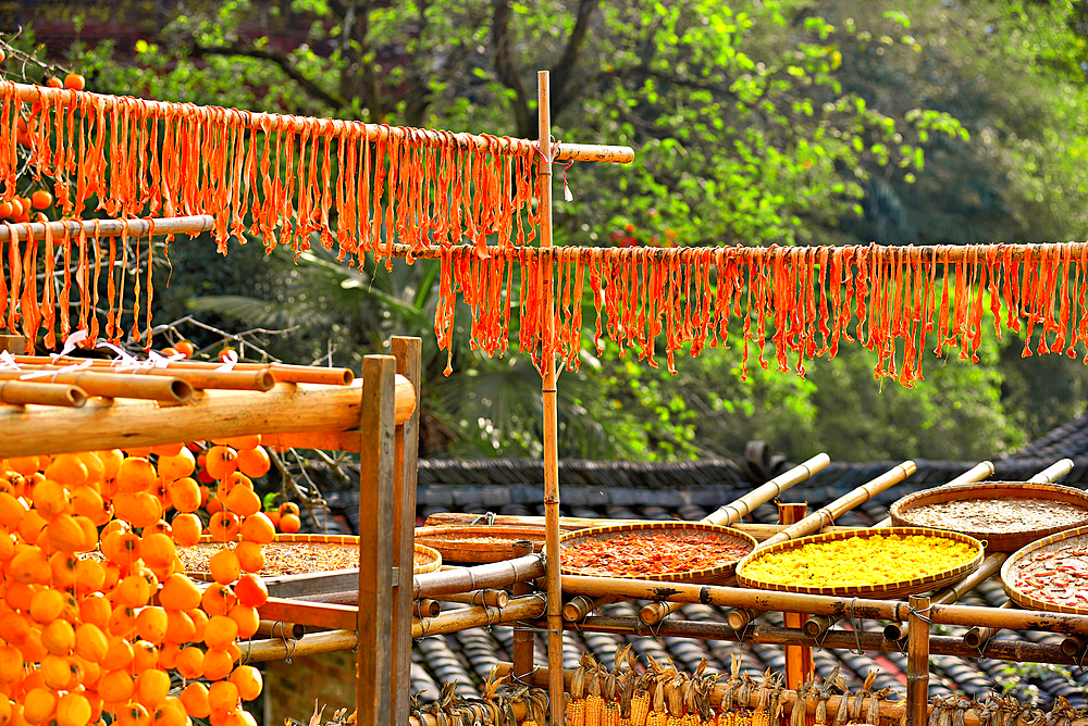 Pumpkin strips and other produce being sun dried in autumn, Huangling, Wuyuan County, Shangrao City, Jiangxi Province, China. Huangling is an ancient village that dates back to the Ming Dynasty more than 500 years ago and is known for its natural beauty.