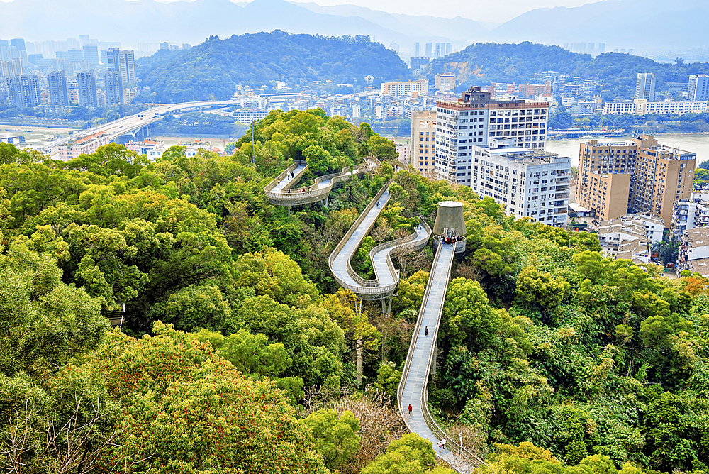 Fuzhou city view and FuDao (Fortune Walkway), Fuzhou, Fujian Province, China. FuDao is a picturesque 19km elevated walkway straddling several hills and parks in Fuzhou.