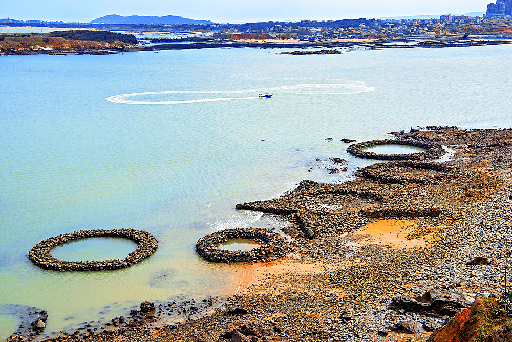 Circular and star shaped rock pools by the sea. Pingtan Island, Fuzhou City, Fujian Province, China.