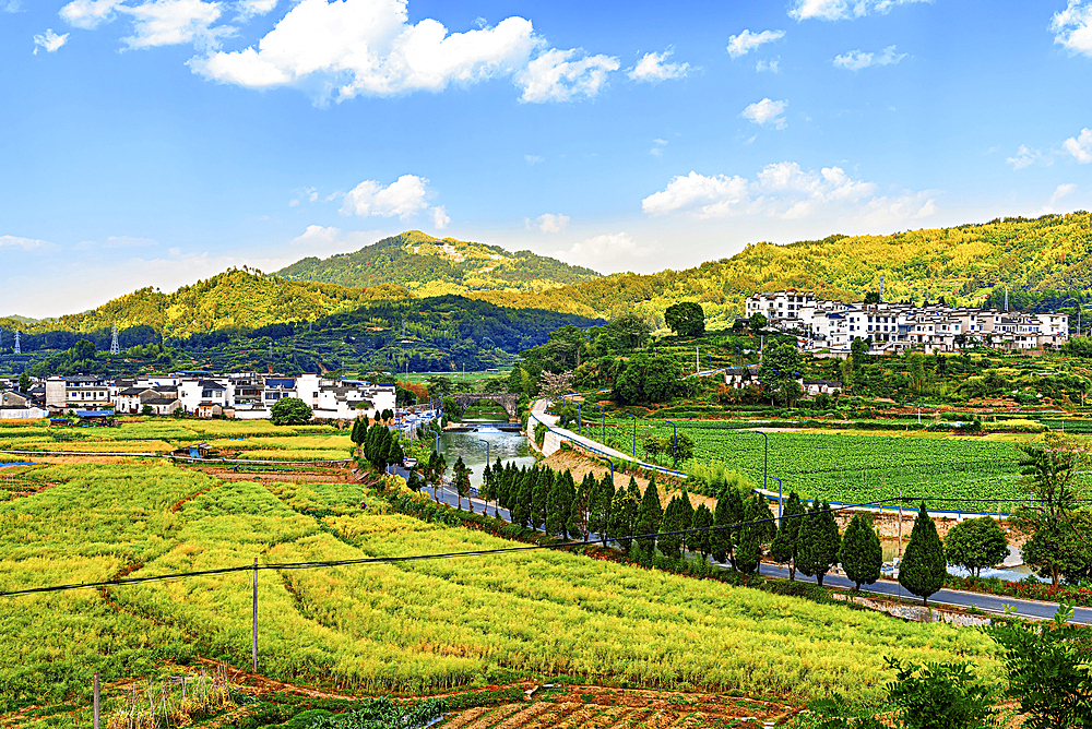 View of new buildings and farms beside Chengkan Ancient Village, Huangshan City, Anhui, China. Chengkan Ancient Village was established 1800 years ago by the Luo family clan. It has buildings dating as early as the Song Dynasty (960 to 1279 AD).