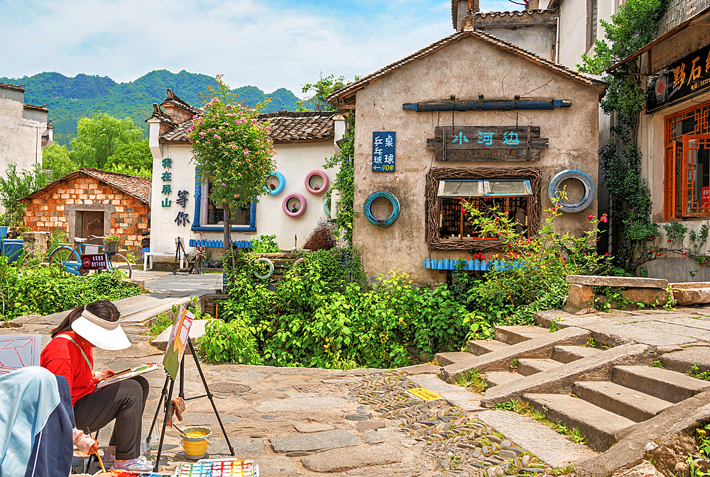 A student painting in Pingshan Ancient Village, Huangshan City, Anhui, China. This millennia old village still retains many historic buildings from the Ming and Qing Dynasty era.