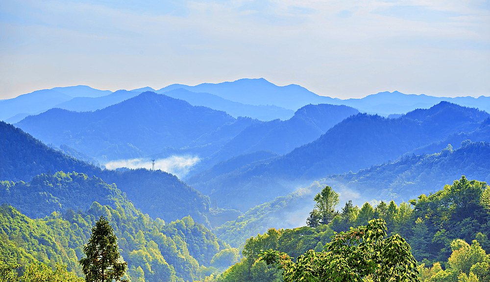 Misty mountains viewed from YangChan Tulou, an ancient earthen buildings village of more than 400 years nestled in the mountains in She County, Huangshan, Anhui Province, China.