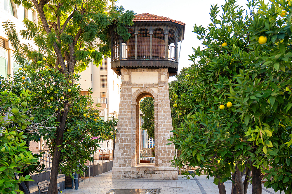Old Historical Water tower with tangerine trees onthe foreground in Rishon Lezion, Israel. City landmark.