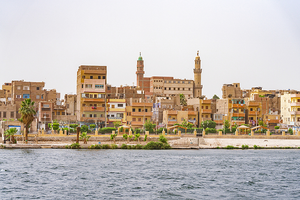Egyptian town and mosque along the banks of Nile River, Egypt