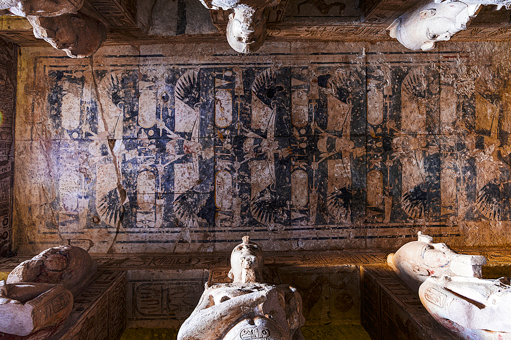 Low angle view of statues and paintings on ceiling inside the Great Temple of Ramses II, Abu Simbel, Aswan, Egypt