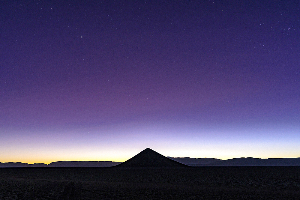 Silhouette of Cono de Arita at sunrise, Salar de Arizaro, Puna, Salta, Argentina