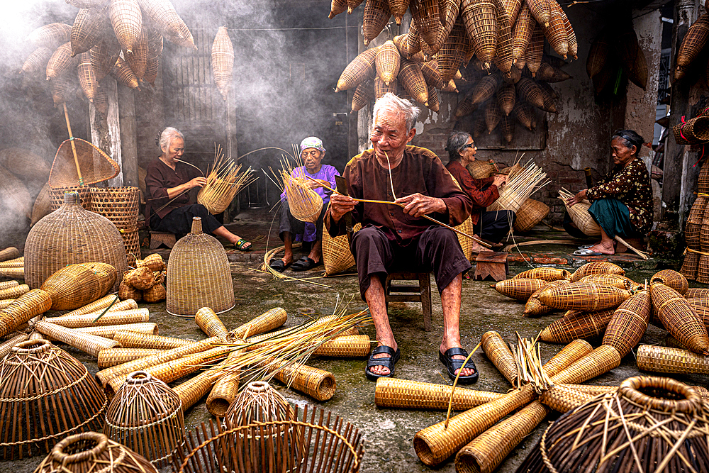 Local people crafting traditional bamboo fish traps, Hanoi, Vietnam. (MR)
