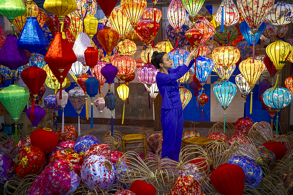 Woman arranging colorful lanterns in a workshop, Hoi An, Quang Nam Province, Vietnam. (MR)