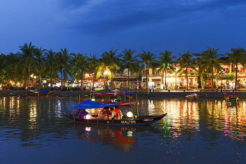 Tourist boats on the illuminated Thu Bon River at dusk, Hoi An, Quang Nam Province, Vietnam
