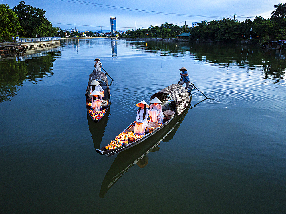 Women on boats carrying candle lanterns in a prayer ritual, Nhu Y River, Hue, Central Vietnam. (MR)